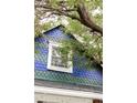 Close-up of the home's shingled facade with blue-green colored shingles and white trim at 3346 W 30Th Ave, Denver, CO 80211