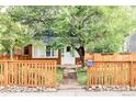 Charming brick home with a well-maintained front yard and a wooden fence, creating a welcoming curb appeal at 3346 W 30Th Ave, Denver, CO 80211