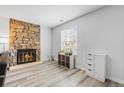 Inviting living room with a stone fireplace, modern floors, and ample natural light for cozy gatherings at 8462 Everett Way # B, Arvada, CO 80005