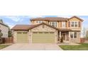 Inviting home with a three-car garage, stone accents, and well-maintained landscaping at 13664 Cherry St, Thornton, CO 80602