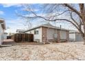 Exterior view of a house with a fenced yard, brick accents, and tidy landscaping at 2027 Terry St # 1, Longmont, CO 80501