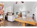 Bright kitchen with stainless steel appliances, granite countertops, and white cabinets, flowing into an adjacent dining area at 2027 Terry St # 1, Longmont, CO 80501