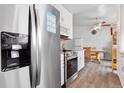 Bright kitchen with stainless steel appliances, white cabinetry, and wood floors at 2027 Terry St # 1, Longmont, CO 80501