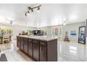 Expansive open-concept living area with marble flooring, ample light, and kitchen island view at 525 Willow Dr, Brighton, CO 80603