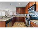 This updated kitchen features granite countertops, stainless steel appliances, and ample cabinet space at 9792 Mayfair St # F, Englewood, CO 80112