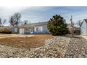 Beautifully maintained home featuring a lush front yard and an attached garage, creating a welcoming curb appeal at 3041 S Glencoe St, Denver, CO 80222