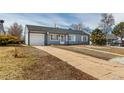 Delightful home with a classic design, showcasing a neat front lawn and attached garage for convenience at 3041 S Glencoe St, Denver, CO 80222