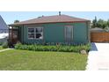 Single-story home with well-maintained lawn and flower beds; driveway to the right at 1730 W 51St Ave, Denver, CO 80221