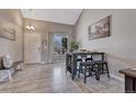 Bright dining area with tile floors, mountain art, and a table set for a meal at 3689 Primrose Ln, Castle Rock, CO 80109