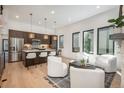 Bright living room featuring modern white furniture, wood flooring, and lots of natural light at 21 Washington Ave, Golden, CO 80403