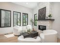 Bright living room featuring modern white furniture, wood flooring, fireplace, and lots of natural light at 21 Washington Ave, Golden, CO 80403