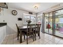 Charming dining area with a modern table set, windows and access to the outdoor patio at 10474 W Purgatoire Peak, Littleton, CO 80127