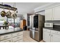 Open kitchen with stainless steel appliances and adjacent dining area at 10474 W Purgatoire Peak, Littleton, CO 80127