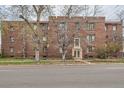 Traditional brick apartment building featuring a symmetrical design and mature landscaping at 2115 E 14Th Ave # 8, Denver, CO 80206