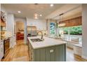Bright kitchen boasts a large island with seating, stainless steel appliances, and a cozy breakfast nook at 8229 Cottongrass Ct, Castle Pines, CO 80108