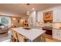 Stylish kitchen featuring an island with seating, stainless steel appliances, and an open view of the living area at 8229 Cottongrass Ct, Castle Pines, CO 80108