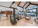 Open-concept living room with kitchen, vaulted ceilings, and large windows overlooking snowy landscape at 444 Glen Eagle Loop, Breckenridge, CO 80424