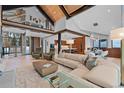 Spacious living room with staircase, kitchen, and dining area with high ceilings at 444 Glen Eagle Loop, Breckenridge, CO 80424