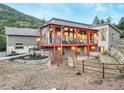 House exterior showcasing a deck, stone retaining wall, and mountain views at 4840 Limestone Rd, Monument, CO 80132