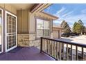 Inviting front porch with storm door and decorative stone accents, leading into the residence at 7370 S Catawba Way, Aurora, CO 80016