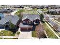 Aerial view of the home showcasing its well-maintained lawn and proximity to neighborhood streets at 11703 S Rock Willow Way, Parker, CO 80134