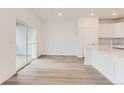 Open-concept living area with wood flooring and a sliding door at 587 Nightsky St, Erie, CO 80516