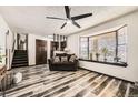 Bright living room with attractive floors, large window, and traditional design elements throughout at 710 S Grand Ave, Fort Lupton, CO 80621