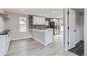 Bright kitchen with stainless steel appliances, white cabinets, decorative backsplash, and an eat-in island at 6880 Pontiac St, Commerce City, CO 80022