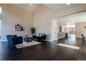 Bright living room with high ceilings and dark wood floors flowing into the kitchen at 1270 Olive St, Denver, CO 80220