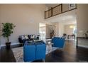 Open-concept living room featuring soaring ceilings, hardwood floors, and modern decor at 1270 Olive St, Denver, CO 80220