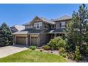 Beautiful two-story home with three-car garage, stone accents, and lush landscaping at 26764 E Canyon Ave, Aurora, CO 80016