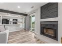 Open-concept living room with fireplace, modern decor, and sliding glass door to balcony at 4899 S Dudley St # 14F, Littleton, CO 80123