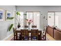 Dining room with a large glass topped table, seating for six, with view to yard at 7080 W Custer Ave, Lakewood, CO 80226