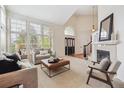 Bright living room featuring a fireplace, large windows, and comfortable seating at 2317 Wynterbrook Dr, Highlands Ranch, CO 80126