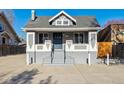 Charming home with a symmetrical facade, prominent front steps, and gray color scheme at 3929 Federal Blvd, Denver, CO 80211