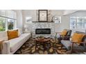 Cozy living room featuring a modern fireplace, comfortable seating, and stylish decor at 3929 Federal Blvd, Denver, CO 80211