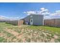 Exterior view of the barn featuring a wooden fence for privacy at 32800 E 137Th Way, Brighton, CO 80603