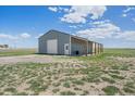 Well-maintained barn/workshop featuring a large door, covered awning, and ample storage space at 32800 E 137Th Way, Brighton, CO 80603