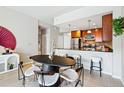 Cozy dining area with modern table and chairs, open to the updated kitchen with granite counters and stainless appliances at 1975 N Grant St # 810, Denver, CO 80203