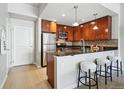 The kitchen features stainless appliances, granite countertops and bar stool seating, offering style and convenience at 1975 N Grant St # 810, Denver, CO 80203
