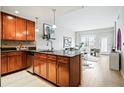 This kitchen and living room area features granite countertops, stainless appliances, and an open layout, perfect for entertaining at 1975 N Grant St # 810, Denver, CO 80203