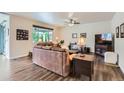 Comfortable living room with hardwood floors, large windows, and neutral paint at 286 Western Sky Cir, Longmont, CO 80501