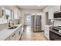 Bright kitchen featuring white cabinets, stainless steel appliances, and modern finishes at 10117 Wyandott N Cir, Thornton, CO 80260