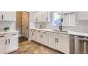 Updated kitchen featuring white cabinets, stainless steel appliances, and a modern sink at 10117 Wyandott N Cir, Thornton, CO 80260