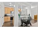 Open-concept kitchen with modern lighting and a convenient breakfast bar at 4100 Albion St # 314, Denver, CO 80216