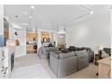 Spacious living room with neutral colors, fireplace and an open view of the kitchen at 4100 Albion St # 314, Denver, CO 80216