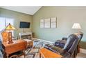 Cozy living room with plush leather seating, a flat-screen TV, and stylish decor at 10349 W Fair Ave # B, Littleton, CO 80127