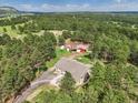 Overhead view of home with red barn and forest, showing its setting and curb appeal at 20125 Indi Dr, Monument, CO 80132