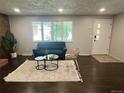 Cozy living room with hardwood floors, a comfortable sofa, and bright natural light at 1088 Douglas Dr, Denver, CO 80221