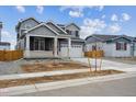 Beautiful two-story home with a two-car garage and a covered front porch entrance at 9996 Racine St, Commerce City, CO 80022
